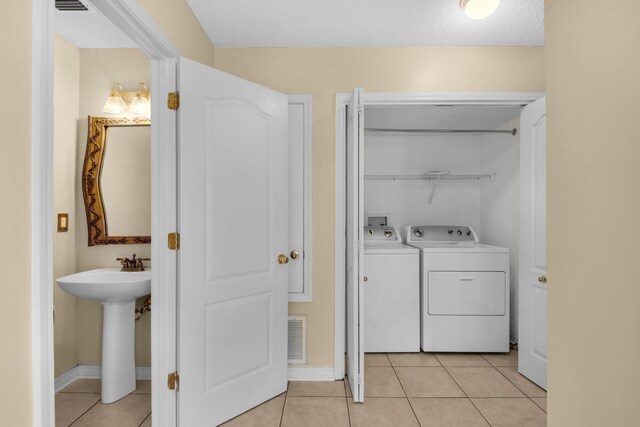 880 Brande Ct, Shalimar, FL 32579 - washroom with washing machine and dryer, light tile patterned floors, and baseboards