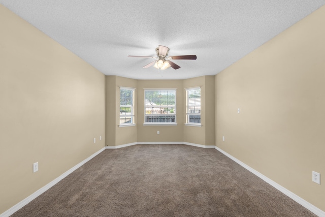 carpeted spare room featuring a textured ceiling and ceiling fan