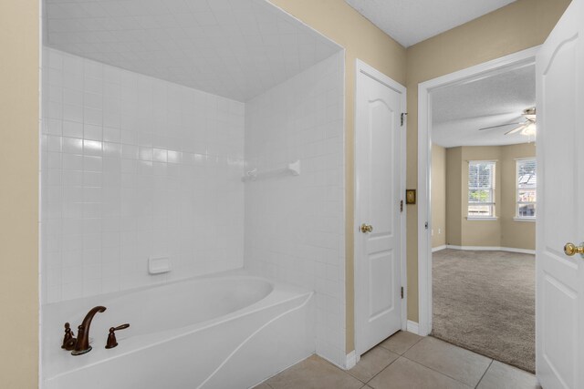 bathroom featuring ceiling fan, tile patterned floors, and a textured ceiling