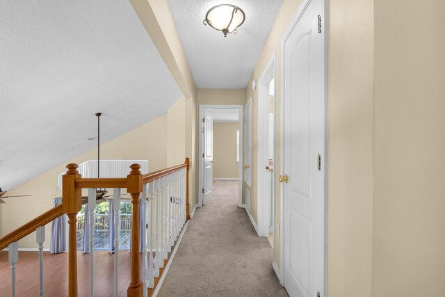 880 Brande Ct, Shalimar, FL 32579 - hallway with a textured ceiling, light carpet, and baseboards
