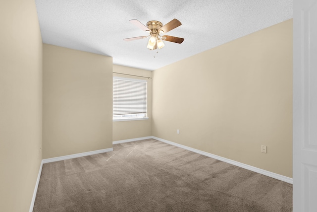 empty room featuring ceiling fan, carpet, and a textured ceiling