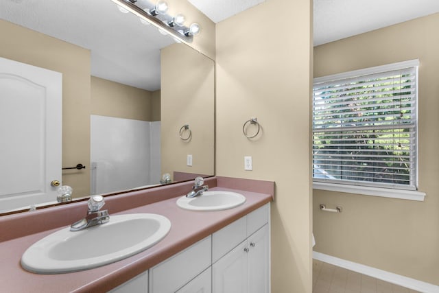 880 Brande Ct, Shalimar, FL 32579 - bathroom with double vanity, toilet, and baseboards