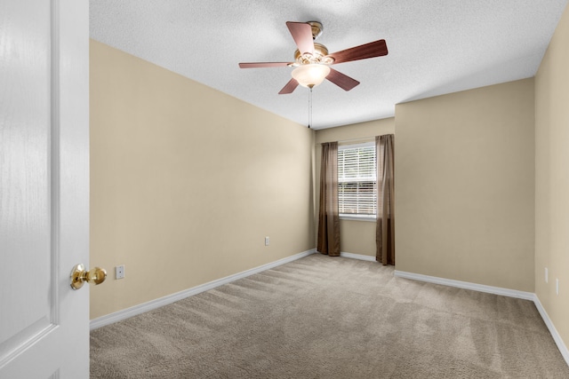 unfurnished room with ceiling fan, light colored carpet, and a textured ceiling