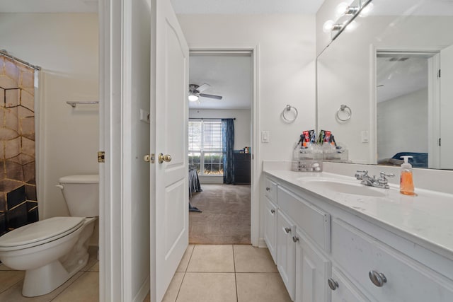 bathroom with ceiling fan, vanity, tile patterned flooring, toilet, and a textured ceiling