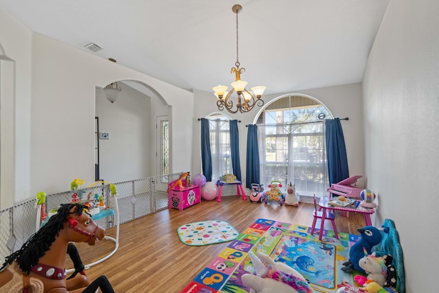 rec room featuring a notable chandelier and hardwood / wood-style floors