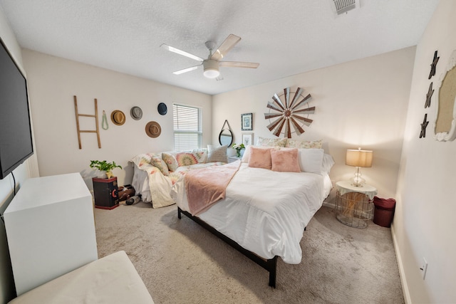 bedroom featuring carpet, a textured ceiling, and ceiling fan