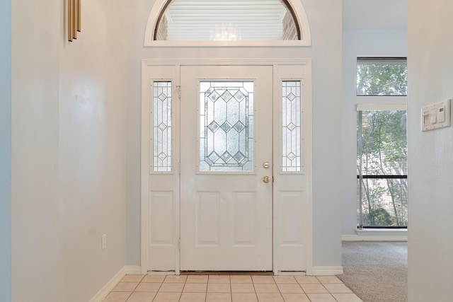 entryway with light carpet and a healthy amount of sunlight