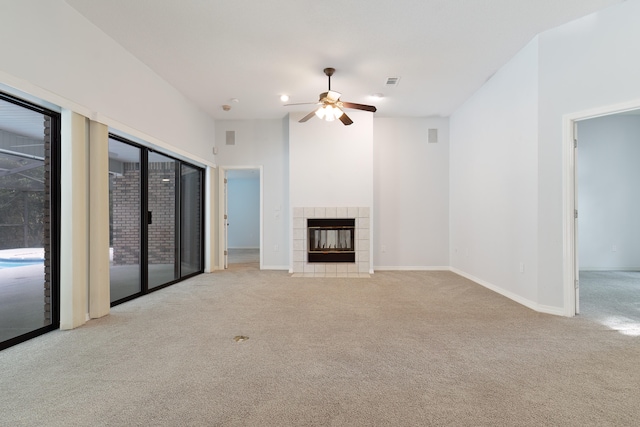 unfurnished living room featuring light colored carpet, ceiling fan, and a fireplace