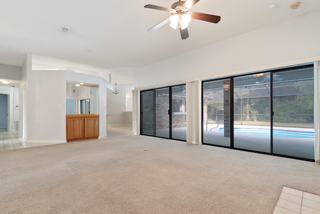 unfurnished room with light colored carpet and ceiling fan