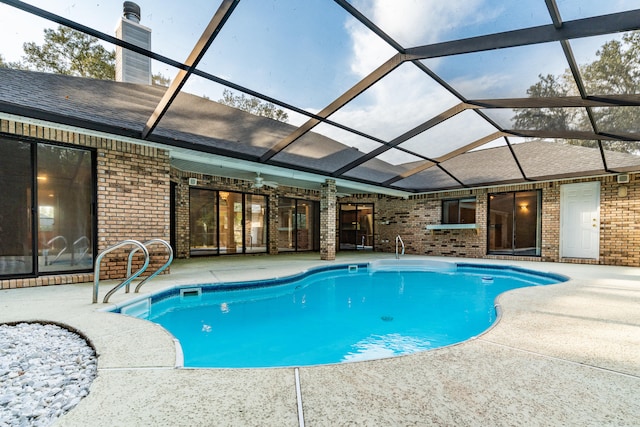 view of pool with a patio and a lanai