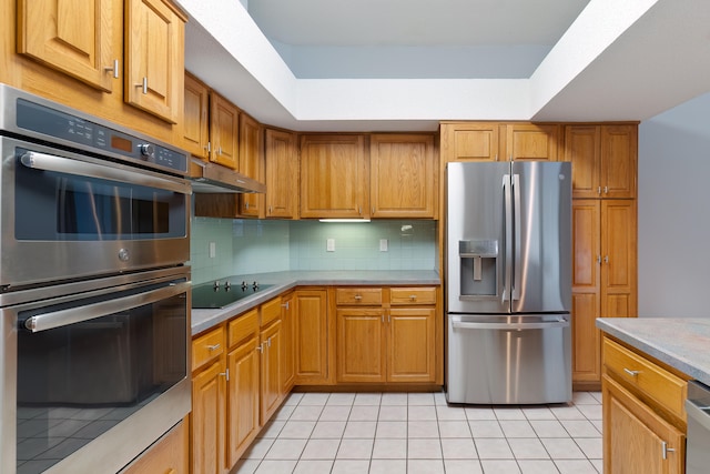 kitchen with stainless steel appliances, light tile patterned floors, and backsplash