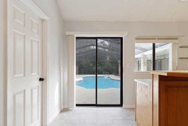 doorway to outside with a healthy amount of sunlight and light tile patterned floors