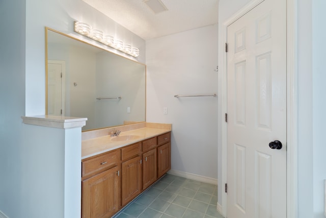 bathroom featuring vanity and a textured ceiling