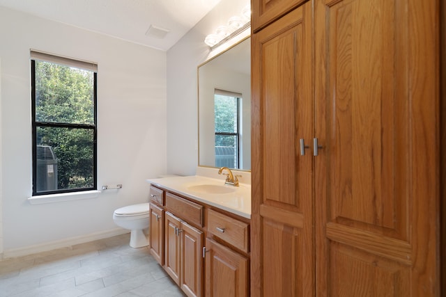 bathroom featuring toilet and vanity