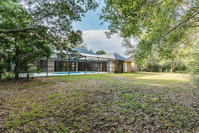 view of yard with glass enclosure