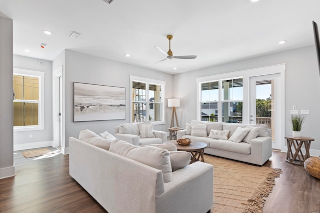 living room with ceiling fan and dark hardwood / wood-style floors