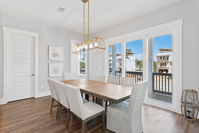 dining room with a notable chandelier and dark hardwood / wood-style flooring