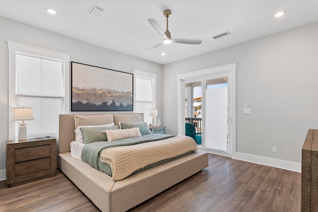 bedroom featuring dark hardwood / wood-style flooring, ceiling fan, and access to exterior