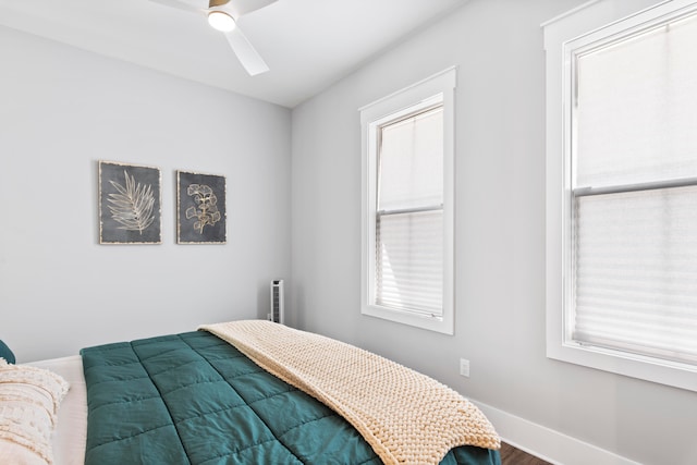 bedroom with ceiling fan and hardwood / wood-style floors