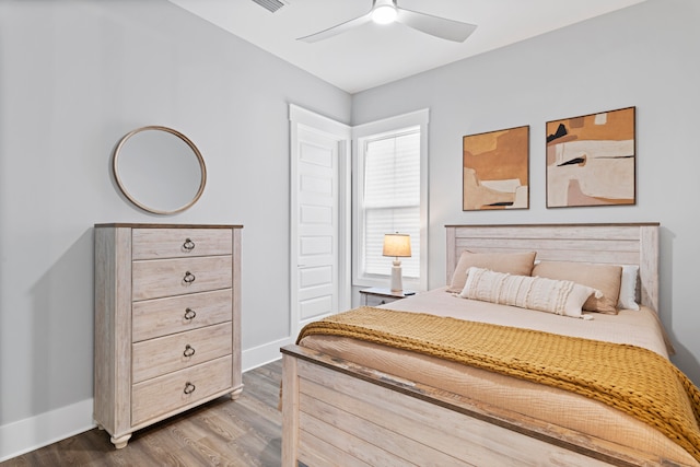 bedroom with ceiling fan and hardwood / wood-style flooring