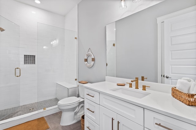 bathroom featuring tile patterned flooring, walk in shower, vanity, and toilet