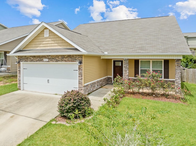 view of front of home featuring a garage and a front lawn