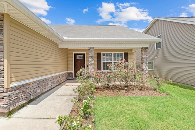 property entrance featuring a lawn