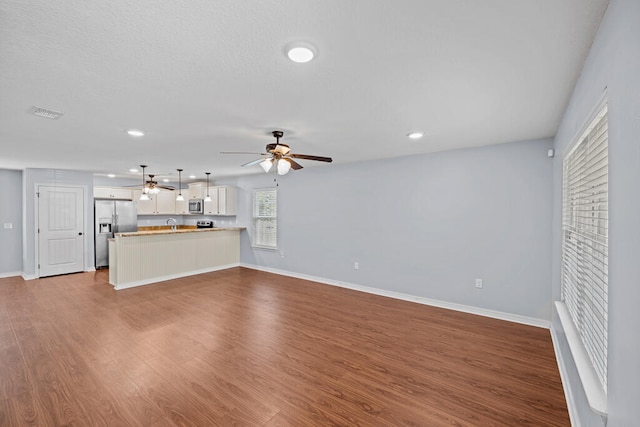 unfurnished living room featuring wood-type flooring