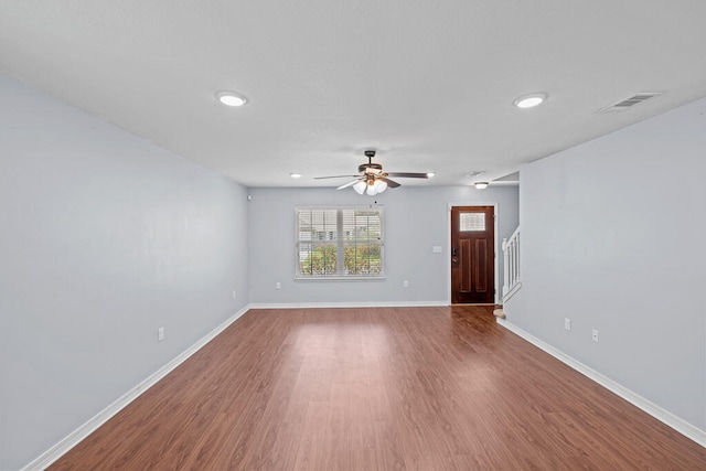 empty room with ceiling fan and hardwood / wood-style floors