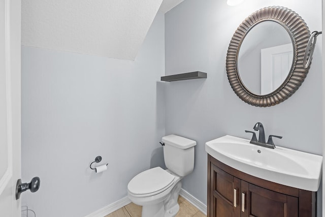 bathroom featuring vanity, toilet, and tile patterned flooring