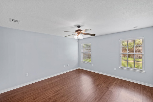 spare room featuring ceiling fan, hardwood / wood-style flooring, and a textured ceiling