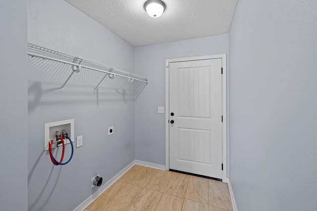 clothes washing area featuring a textured ceiling, electric dryer hookup, and washer hookup