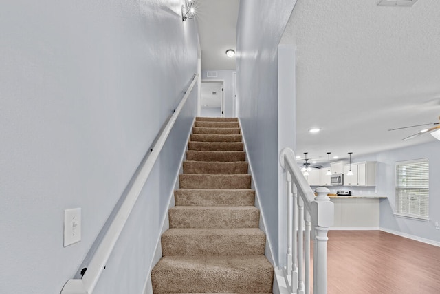 stairs featuring hardwood / wood-style flooring