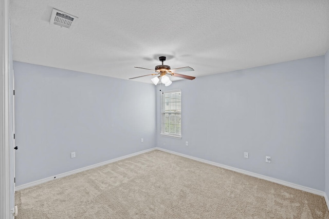 carpeted empty room with a textured ceiling and ceiling fan