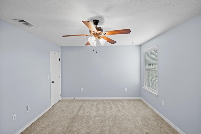 unfurnished room featuring ceiling fan, a textured ceiling, and light colored carpet