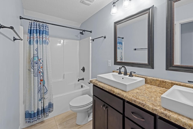 full bathroom with shower / tub combo, a textured ceiling, toilet, tile patterned floors, and vanity