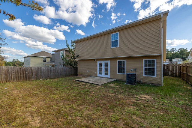 rear view of property with french doors, a patio, and a yard