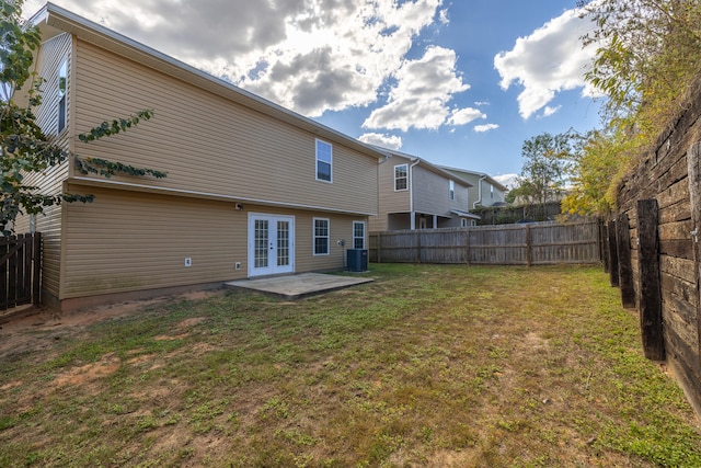 rear view of property with a patio, french doors, a yard, and cooling unit