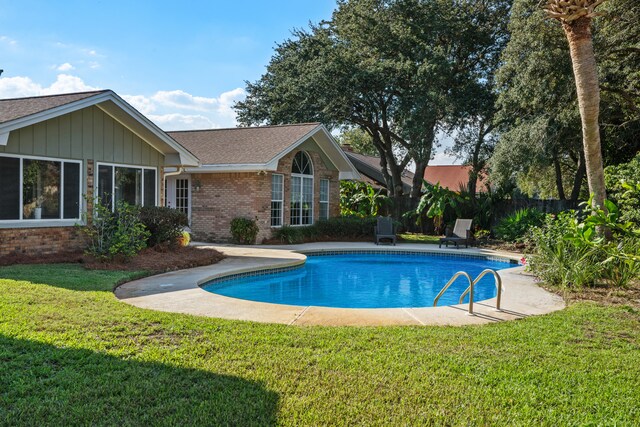 view of pool with a yard