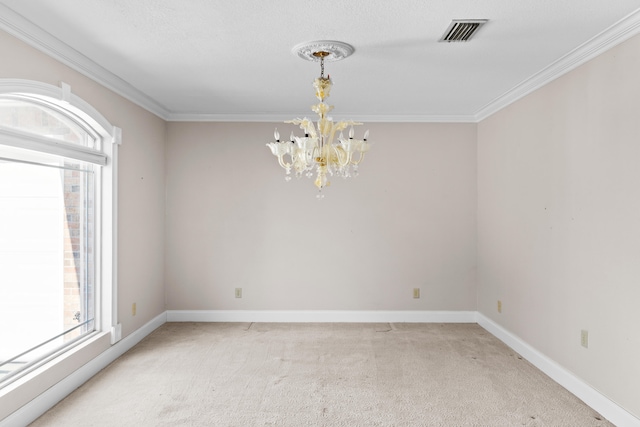 carpeted spare room featuring crown molding and a chandelier