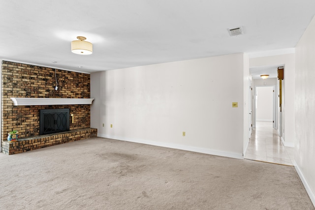 unfurnished living room with carpet and a brick fireplace