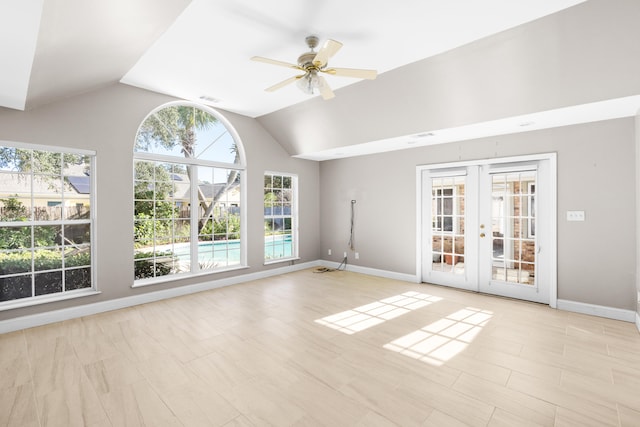 interior space with ceiling fan, lofted ceiling, and french doors