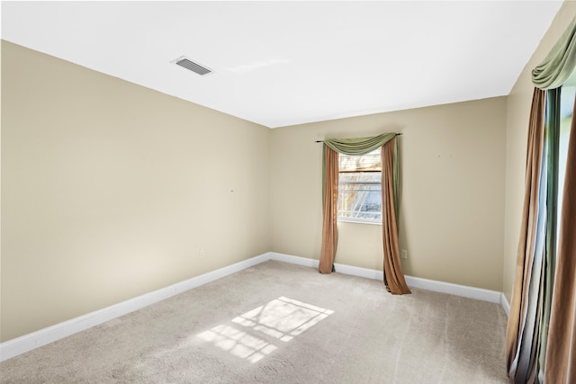 unfurnished room featuring light colored carpet