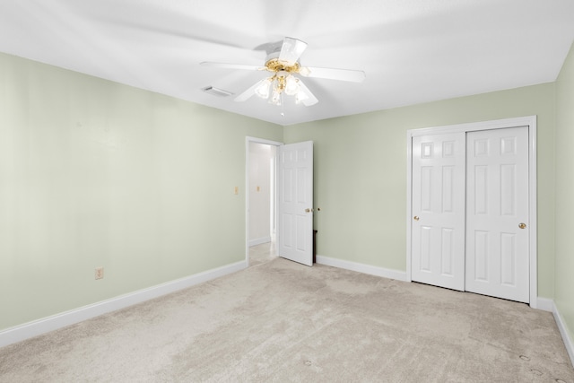 unfurnished bedroom featuring a closet, ceiling fan, and light colored carpet