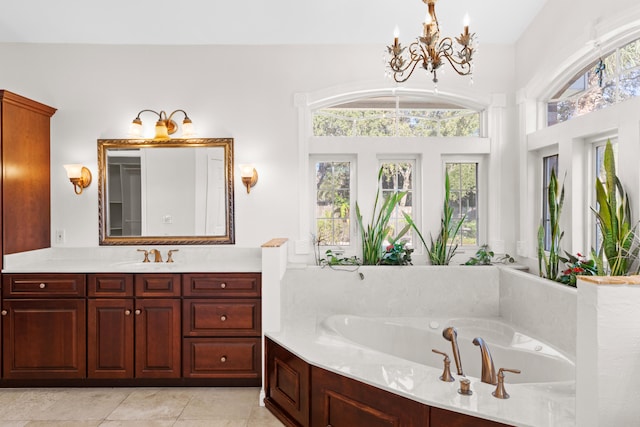 bathroom featuring plenty of natural light, a bath, vanity, and a chandelier