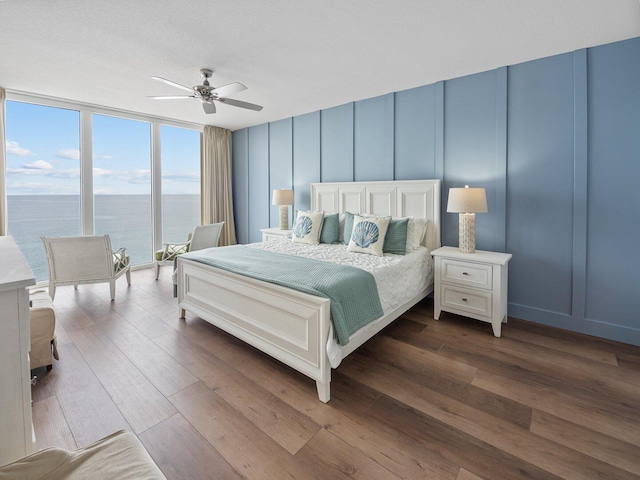 8477 Gulf Blvd Unit 1001, Navarre, FL 32566 - bedroom featuring ceiling fan, a decorative wall, and dark wood finished floors