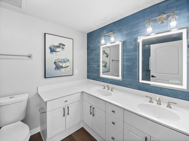 8477 Gulf Blvd Unit 1001, Navarre, FL 32566 - bathroom with a sink, toilet, double vanity, and visible vents