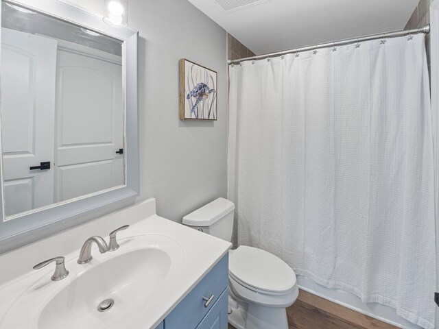 8477 Gulf Blvd Unit 1001, Navarre, FL 32566 - bathroom with vanity, toilet, wood finished floors, and visible vents