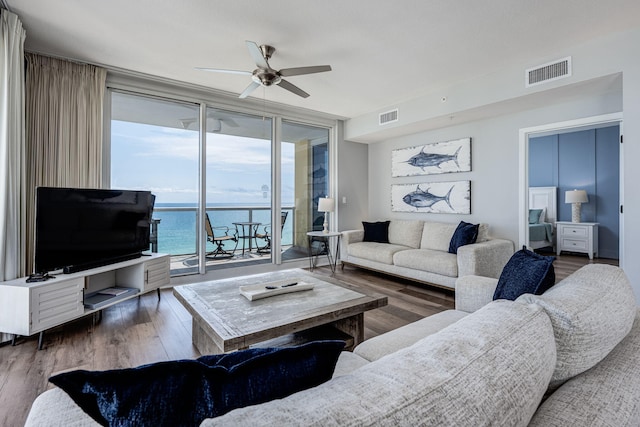 8477 Gulf Blvd Unit 1001, Navarre, FL 32566 - living room with ceiling fan, expansive windows, wood finished floors, and visible vents