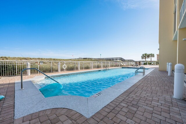 8477 Gulf Blvd Unit 1001, Navarre, FL 32566 - community pool with a patio area and fence